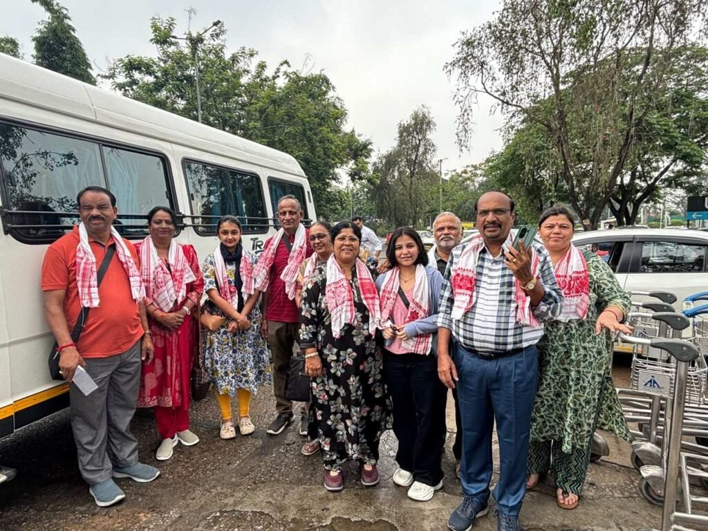 Group of travellers beside a vehicle