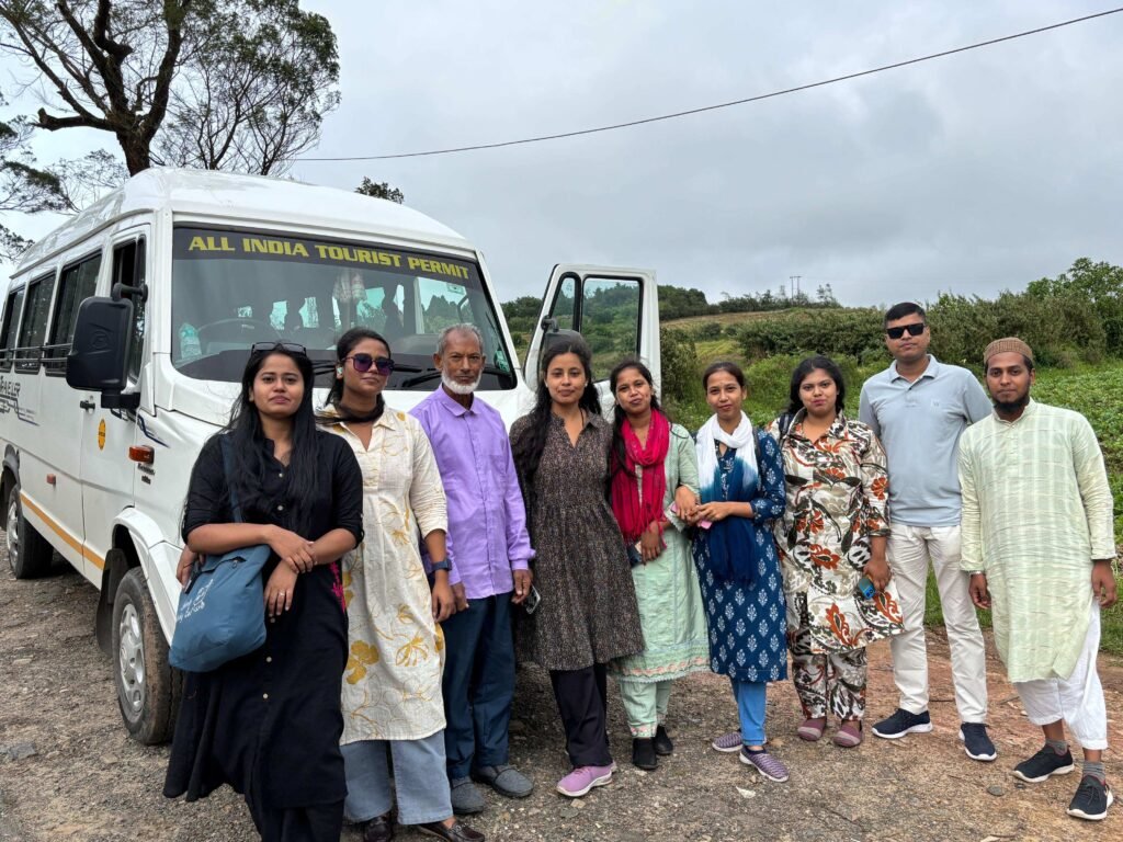 Travellers standing beside a tour vehicle